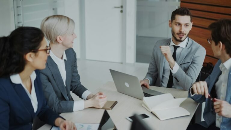 Business team reviewing charts and documents during a proposal discussion