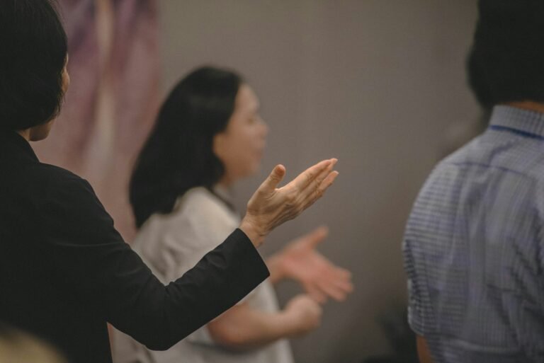 People gesturing with hands during a discussion.
