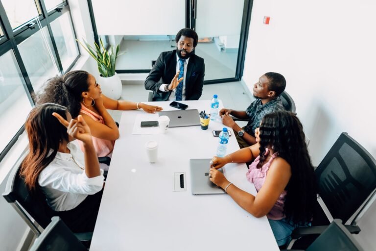 Business professionals engage in a collaborative meeting in a bright Lagos office.