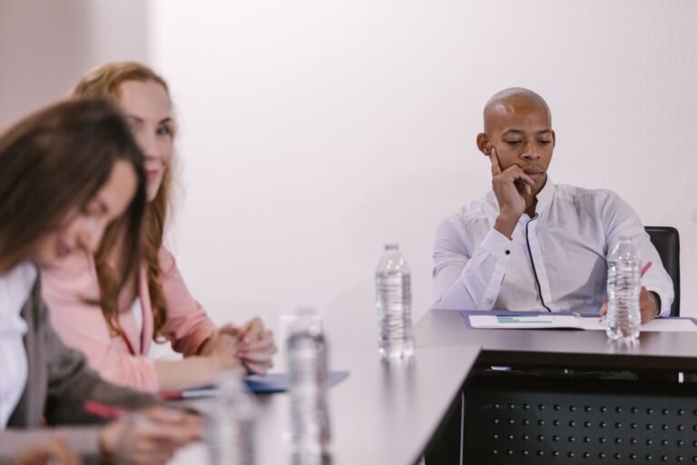 Business professionals engaged in a formal meeting at a conference table.