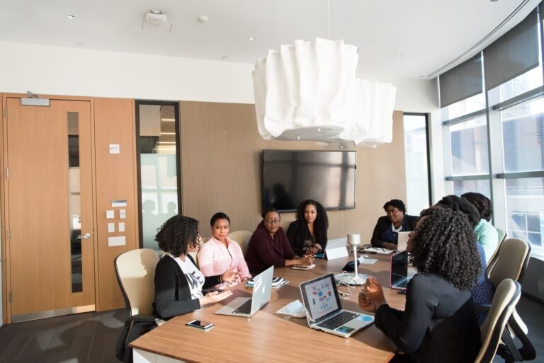 Group of professionals engaged in a strategic meeting in a modern office setting.