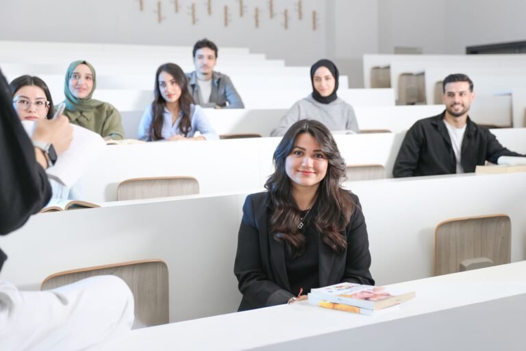 Students listening attentively in a bright university lecture hall.