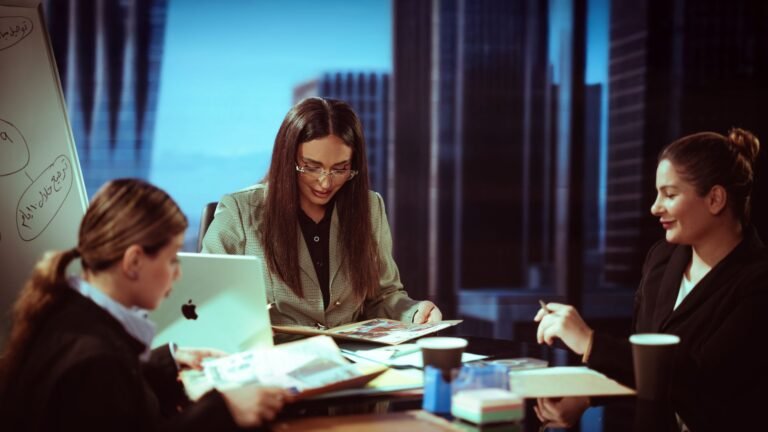 Three businesswomen engaged in a meeting inside a contemporary office.